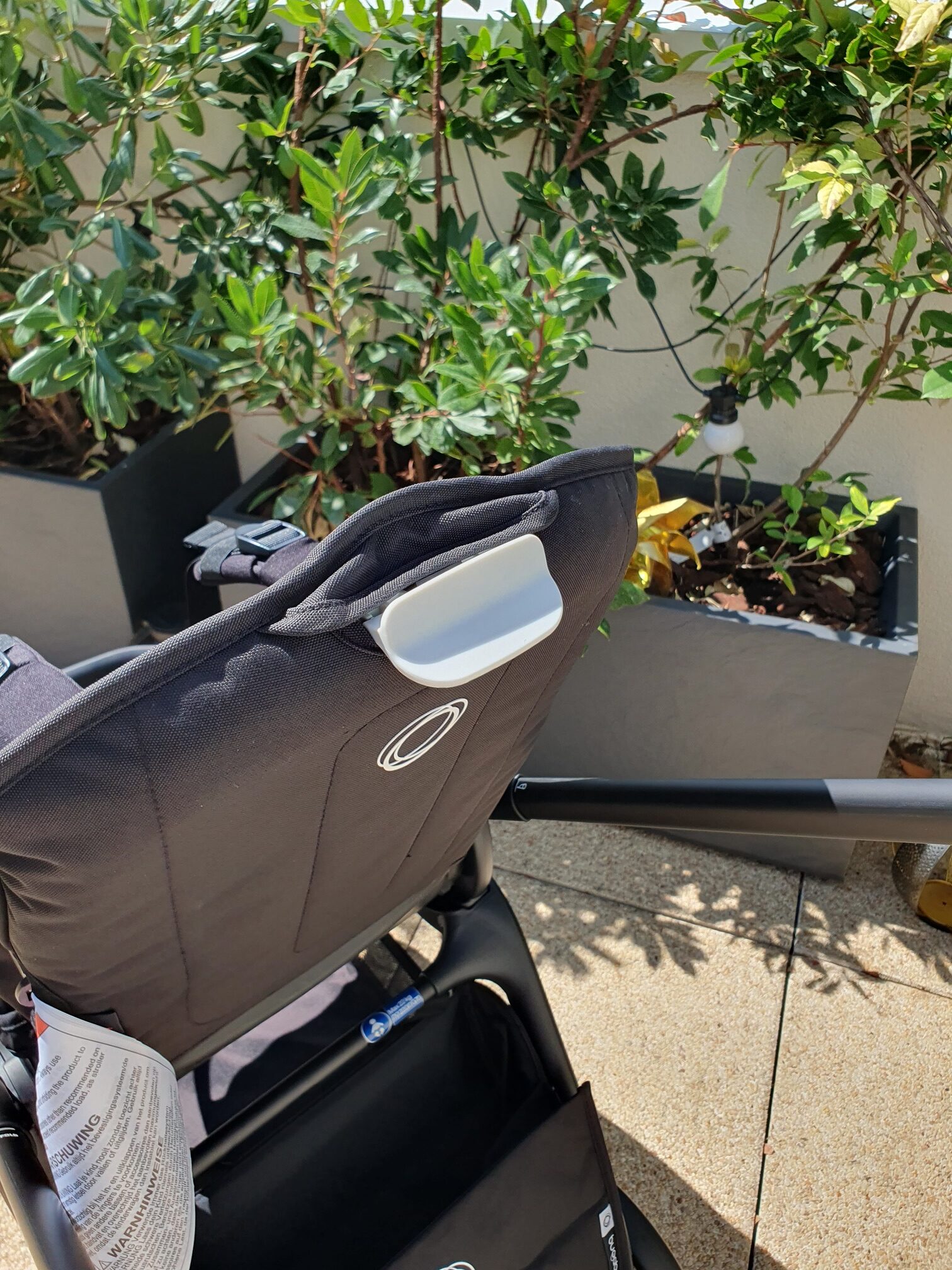 Bouton pour régler le siège de la poussette Dragonfly de Bugaboo.